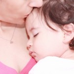 mother kisses baby