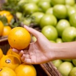 Woman buying orange