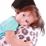 sad child hugging mom